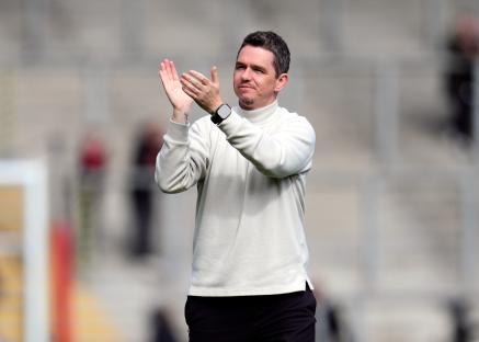 Marc Skinner, Manchester United manager, applauding.
