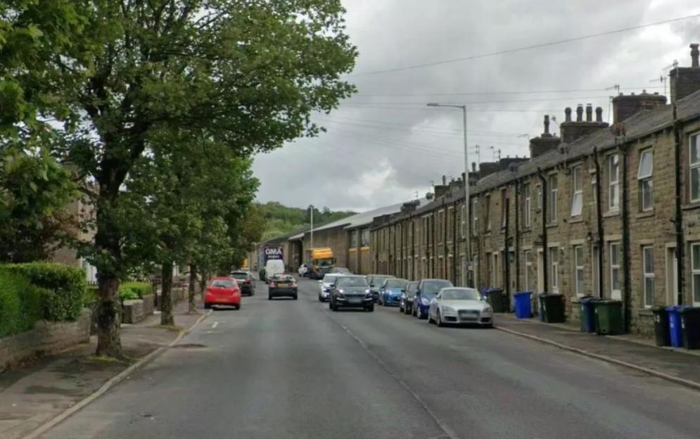 Newchurch Road, Bacup with residential houses and parked cars
