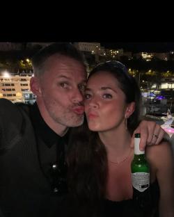 Mia Carragher and a man kissing.