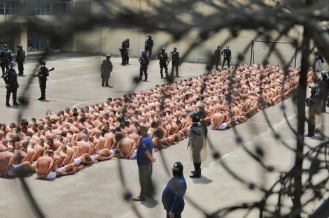 a large group of people are lined up in a prison yard