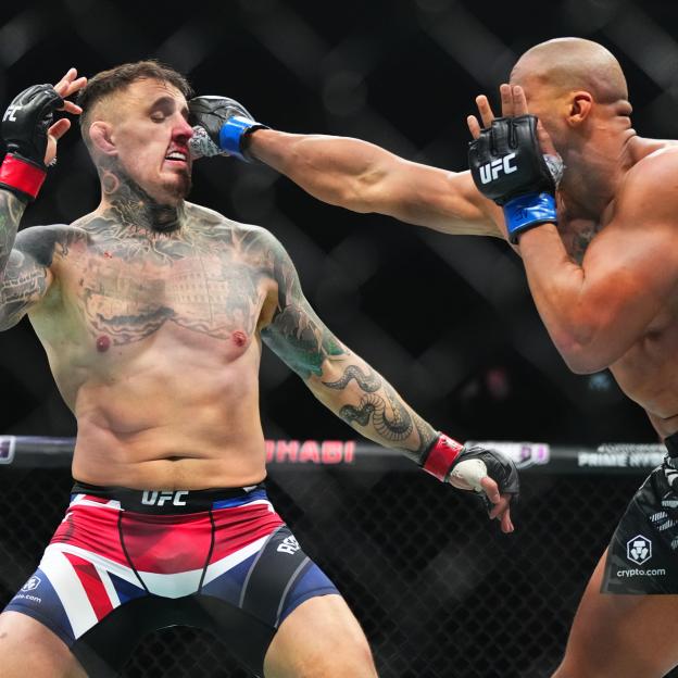 Ciryl Gane punching Tom Aspinall in the face during a UFC heavyweight championship fight.