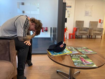 Olympic BMX star Kieran Reilly sits with his head in his hands.