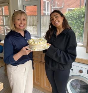 Nelly London and her mother, Yvonne, holding a cake.