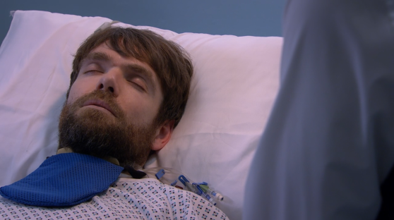 Man sleeping in a hospital bed.