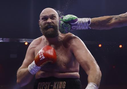 Photo of Tyson Fury being punched during a boxing match.
