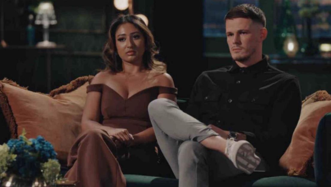 Steven and Nelly from Married At First Sight sitting on a couch.