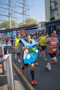 Runner in a Domino's Pizza box costume at a marathon.