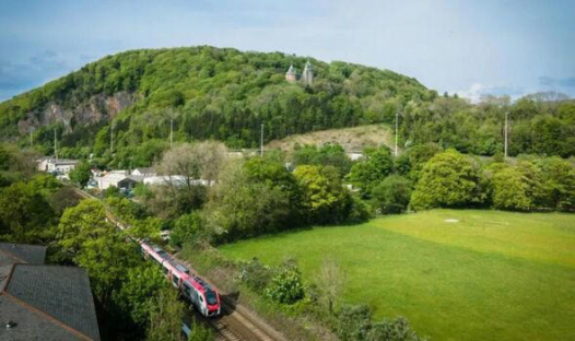 Train traveling through a green valley.