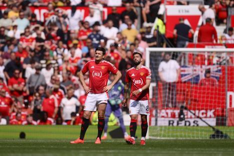 Harry Maguire and Bruno Fernandes of Manchester United looking dejected on the pitch.