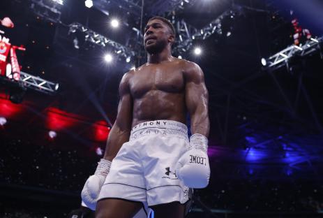 Anthony Joshua boxing in a stadium.