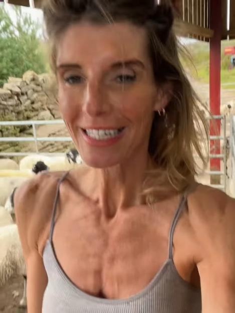 Amanda Owen smiling near sheep.