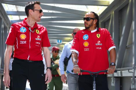 Lewis Hamilton and Riccardo Adami, Ferrari race engineer, walking and talking.