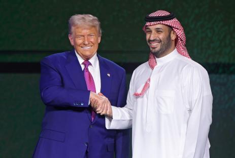 Donald Trump and Mohammed bin Salman shaking hands at an investment forum.