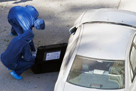 Forensic investigators examine a bomb scene.
