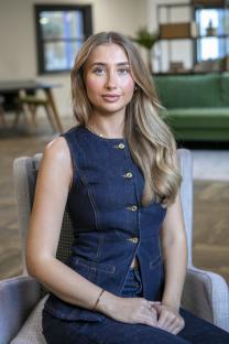 Portrait of Lily Phillips in a denim vest.