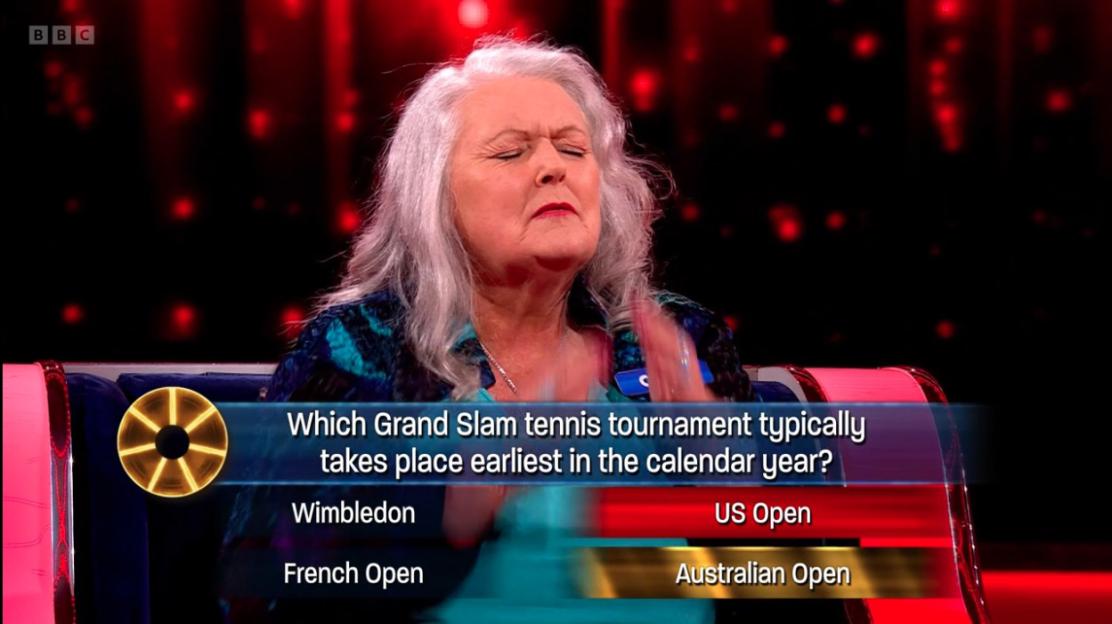 Screenshot of a contestant on "The Wheel" game show answering a question about Grand Slam tennis tournaments.