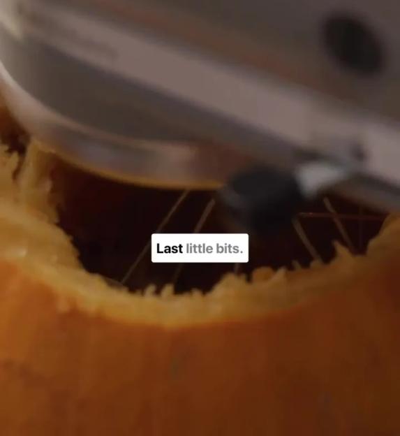 A person carving a Halloween pumpkin.