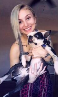 Woman holding a Boston Terrier.