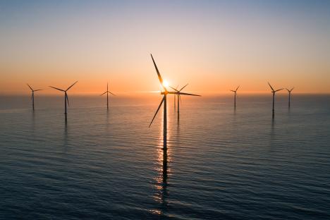 Offshore wind turbines at sunset.