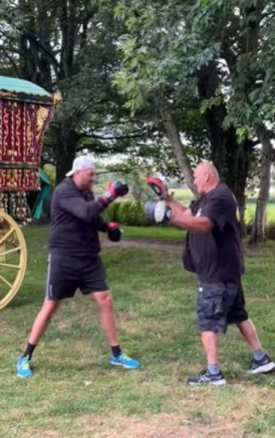 Two men boxing outdoors.