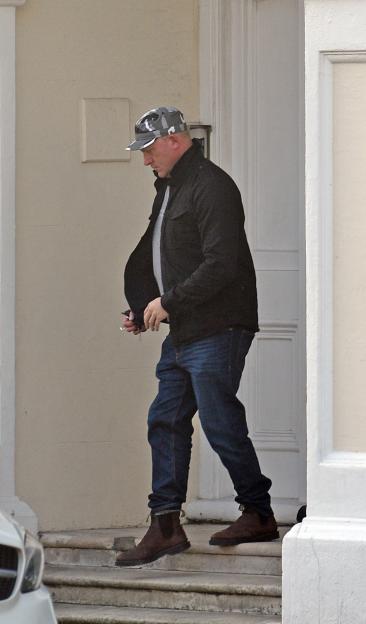 Sam Tarry exiting a seaside flat in Hove.