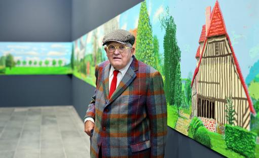 David Hockney standing in front of his painting, 