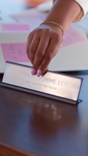 Uma Jammeh's Chief Gloss Officer desk nameplate.