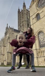 Two girls playing in front of a cathedral.