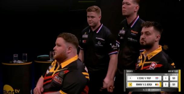 Four darts players during a match.