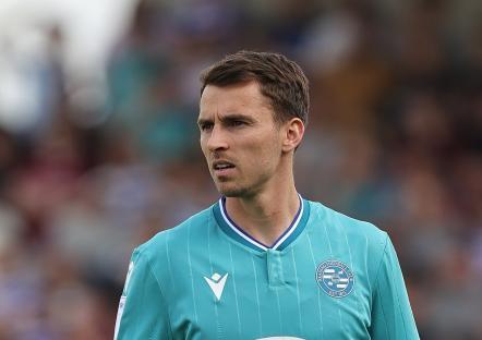 Tom Carroll of Reading F.C. on a soccer field.