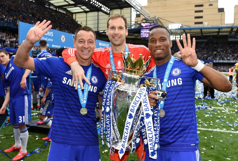 Chelsea F.C. players John Terry, Petr Cech, and Didier Drogba celebrating with the Barclays Premier League trophy.