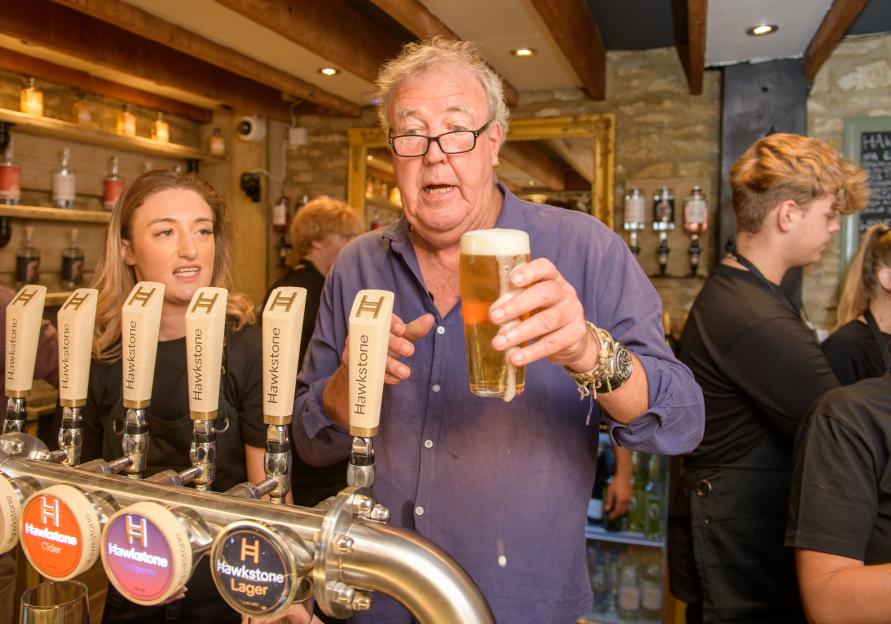 Jeremy Clarkson holding a pint of beer at his pub.