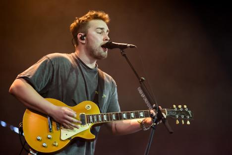 Sam Fender performing at a music festival.