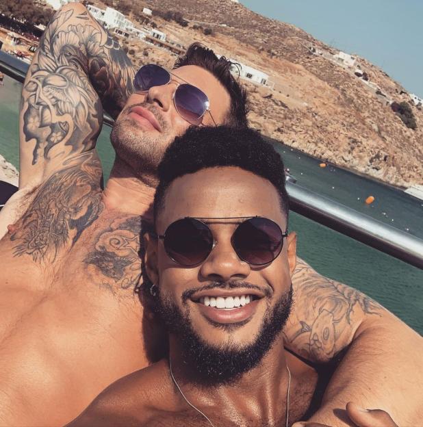 Duncan James of Blue and another man relaxing outdoors.