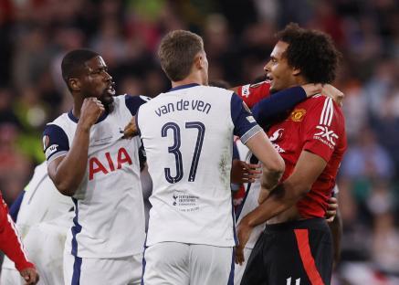 Tottenham Hotspur and Manchester United soccer players interacting on the field.