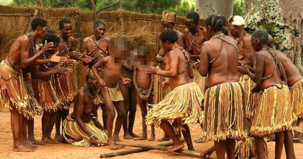 Group of people in traditional clothing performing a ritual.