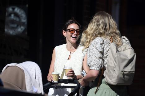 Michelle Keegan and Mark Wright strolling with their baby and coffee cups.