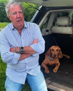Jeremy Clarkson with his dog in the back of a car.