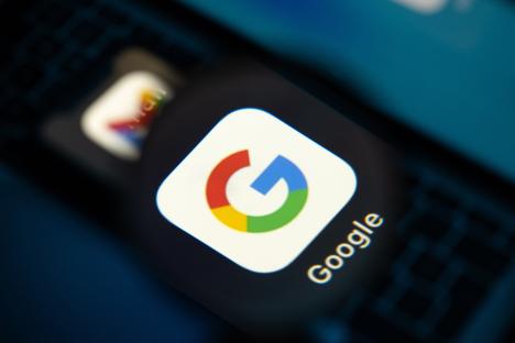Close-up photo illustration of the Google logo on a mobile phone screen.