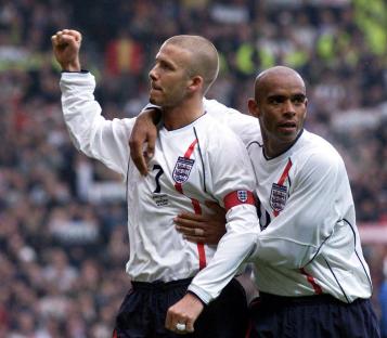 David Beckham and Trevor Sinclair celebrating a goal.