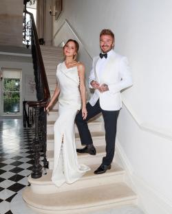 Victoria and David Beckham on a staircase.