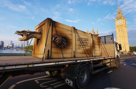 Animatronic dragon on a flatbed truck in London.