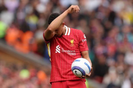 Trent Alexander-Arnold of Liverpool wipes his face during a match.