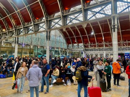 Crowded train station concourse.