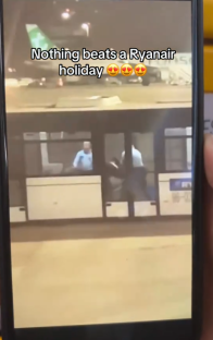 Phone screen showing a woman being removed from a Ryanair flight.
