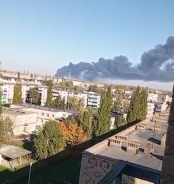 Smoke from an explosion rises over a city.