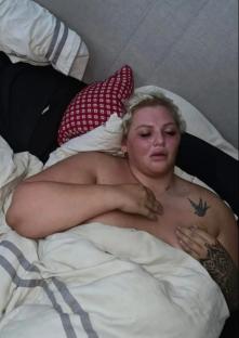 Woman lying in bed, upset.