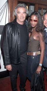 Naomi Campbell, Flavio Briatore, and David Tang at a party.