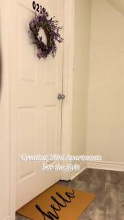 Door to a teenage daughter's apartment with a purple wreath and