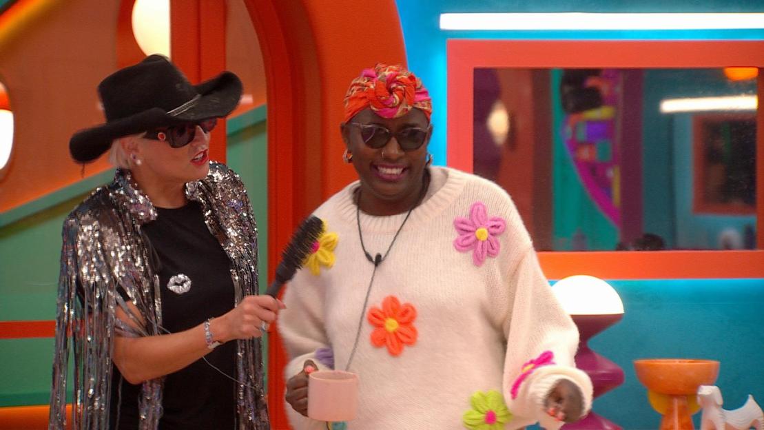 Feyisola with a woman wearing a cowboy hat.